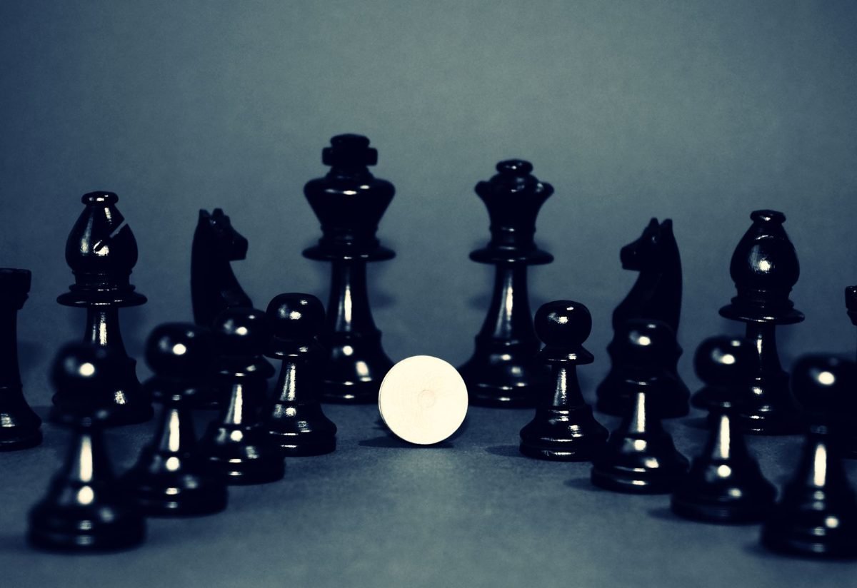Chess pieces on a dark board in low light