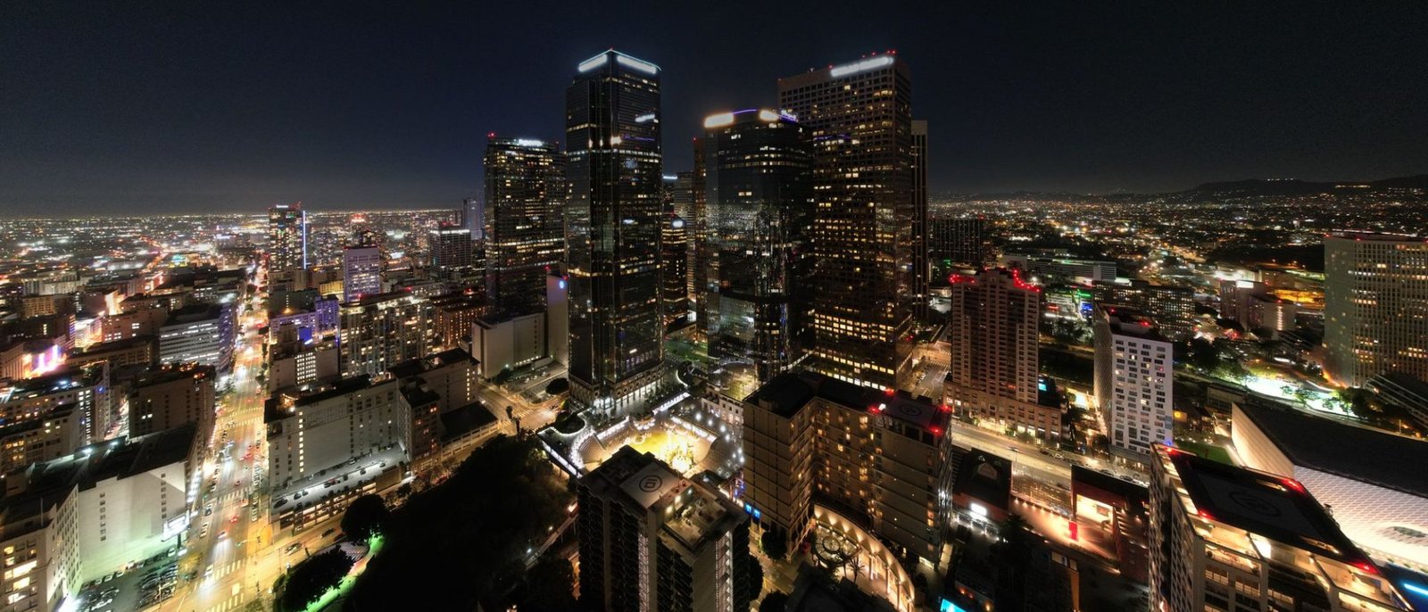 Downtown city towers lit up against a night sky